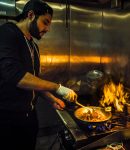 A man cooking Indian and Mediterranean Cuisine at Cedars Restaurant in Seattle Washington.