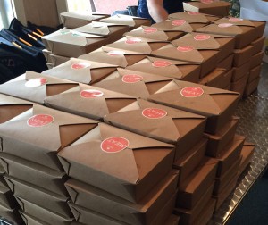 Stacked boxes of Cedars Indian and Mediterranean Cuisine delivered by Peach Delivery Service.